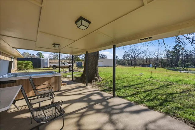a view of a backyard with sitting area