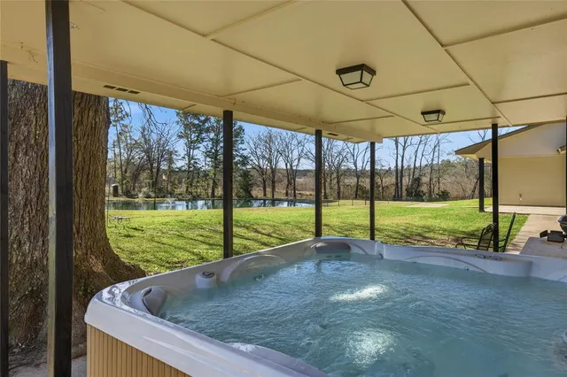 a view of yard with swimming pool and green space