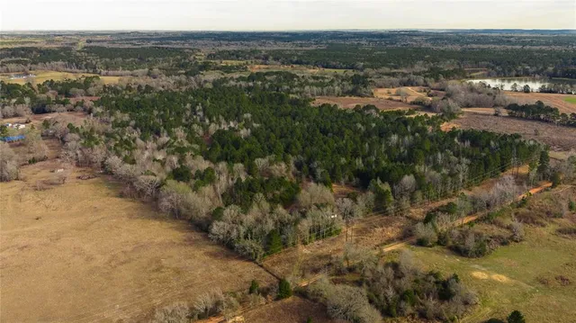 a view of a house with a yard and swimming pool