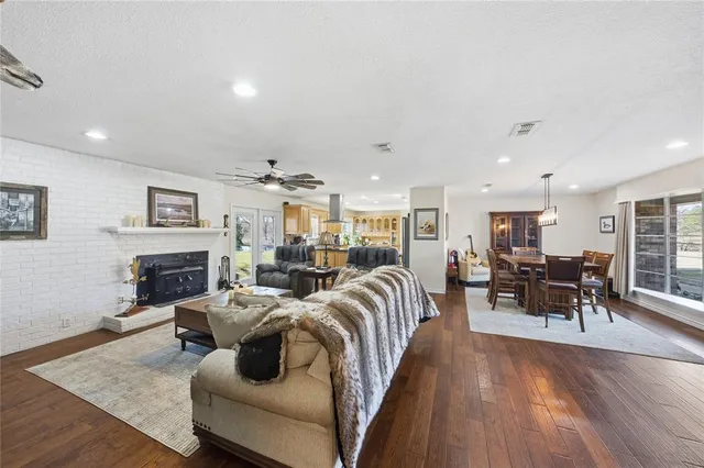 a living room with fireplace furniture and a wooden floor