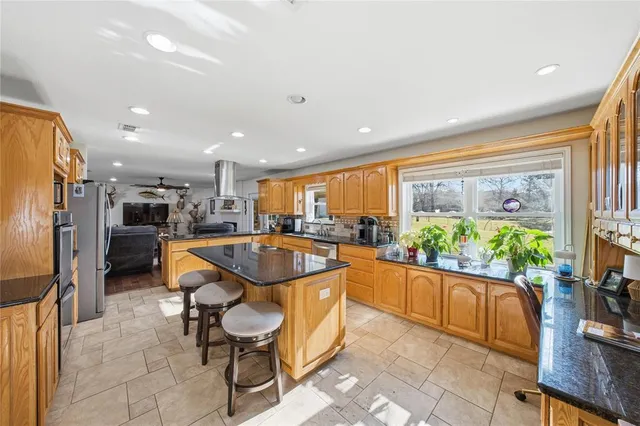 a dining hall with stainless steel appliances a dining table and chairs