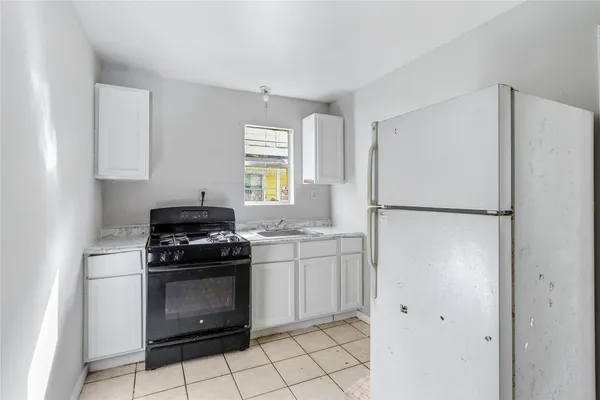 a kitchen with cabinets and steel stainless steel appliances