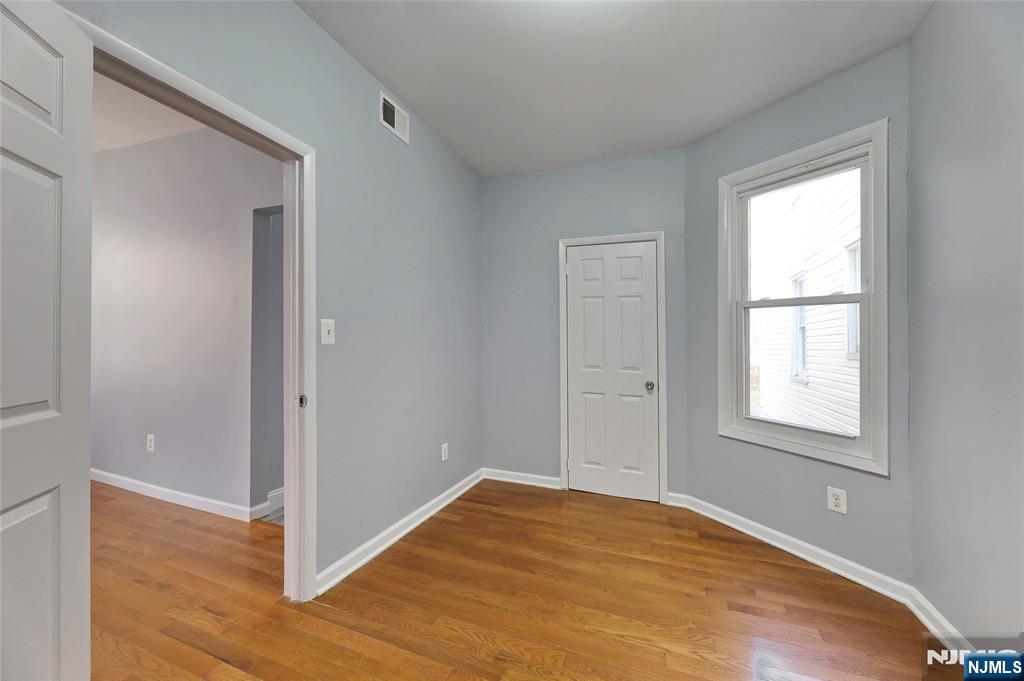 119 Ridgewood Avenue Newark, NJ 07108 - Photo 13 of 38 a view of empty room with wooden floor and fan