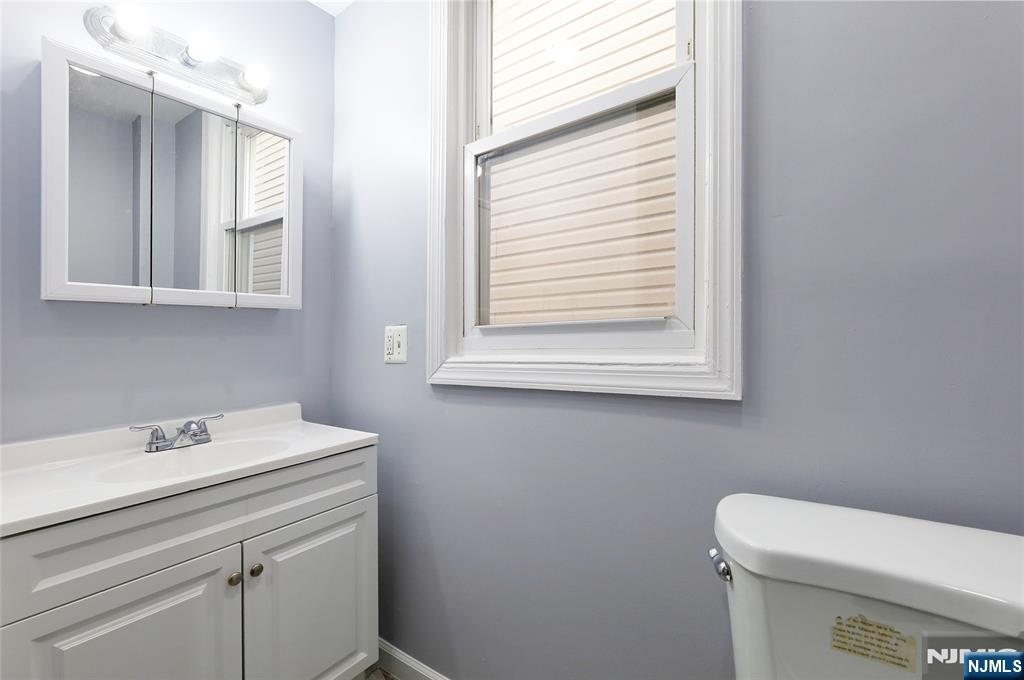119 Ridgewood Avenue Newark, NJ 07108 - Photo 17 of 38 a bathroom with a sink a toilet and a mirror