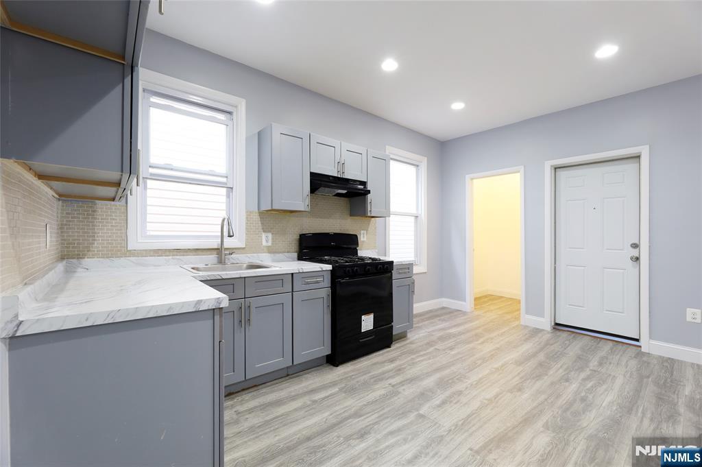 119 Ridgewood Avenue Newark, NJ 07108 - Photo 18 of 38 a kitchen with a sink stove top oven and refrigerator