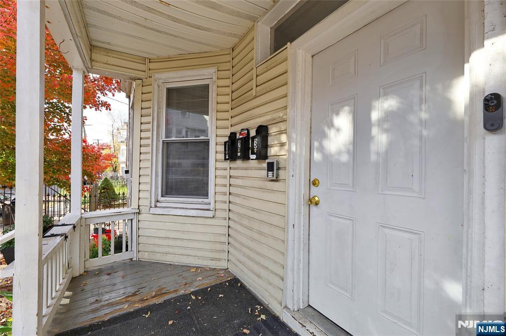 119 Ridgewood Avenue Newark, NJ 07108 - Photo 2 of 38 a view of a porch with a wooden door