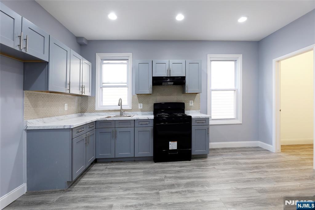 119 Ridgewood Avenue Newark, NJ 07108 - Photo 22 of 38 a kitchen with stainless steel appliances granite countertop a refrigerator and a sink