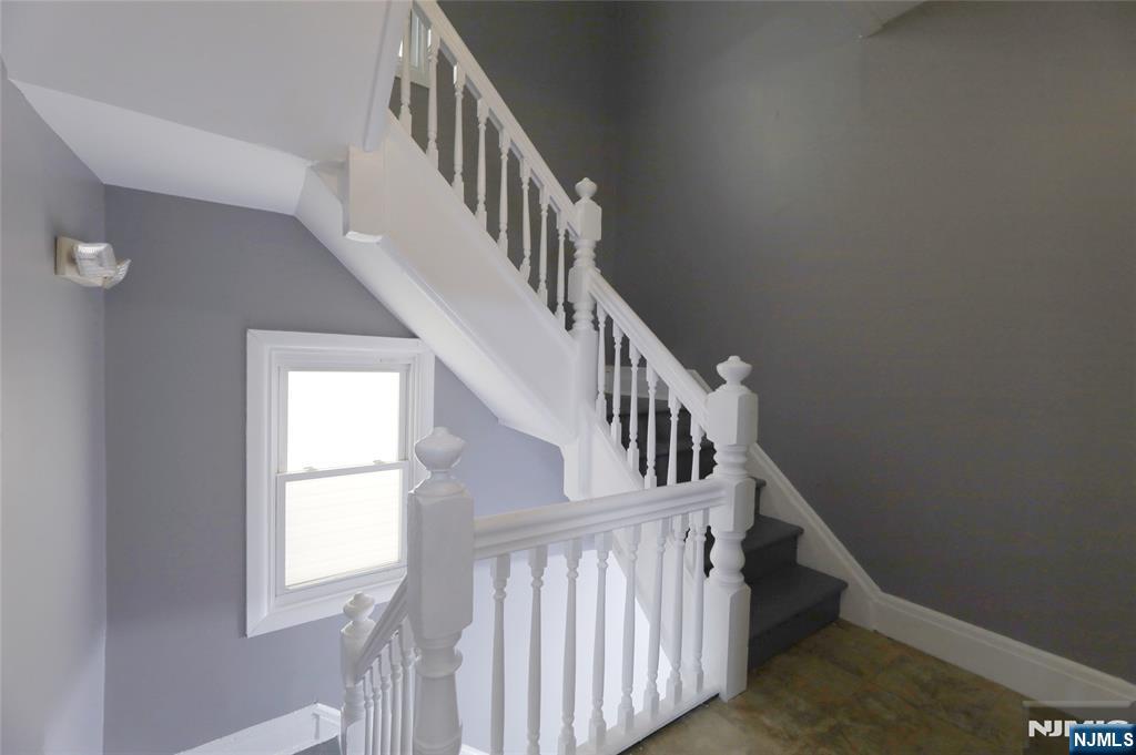 119 Ridgewood Avenue Newark, NJ 07108 - Photo 23 of 38 a view of staircase with railing and a window