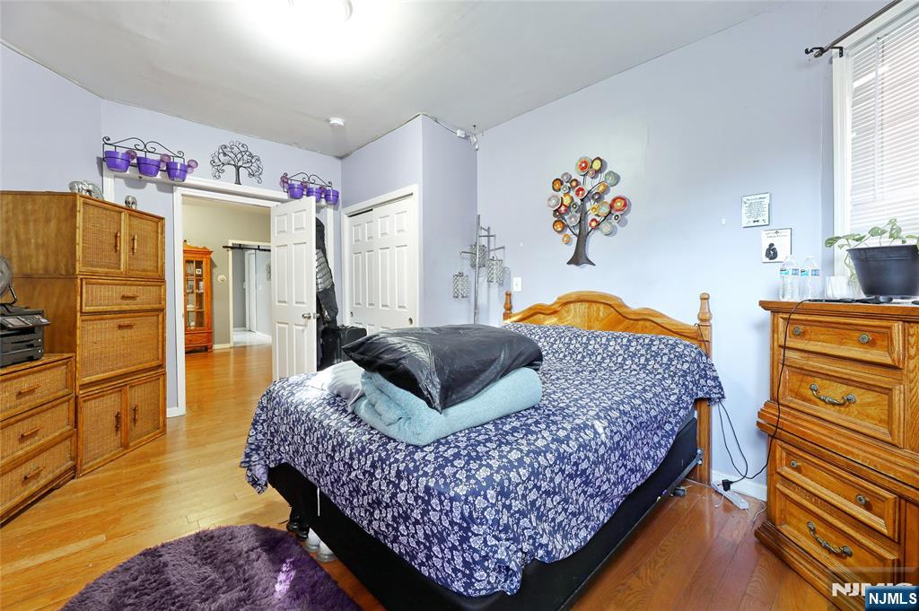 119 Ridgewood Avenue Newark, NJ 07108 - Photo 26 of 38 a bedroom with a bed and wooden floor