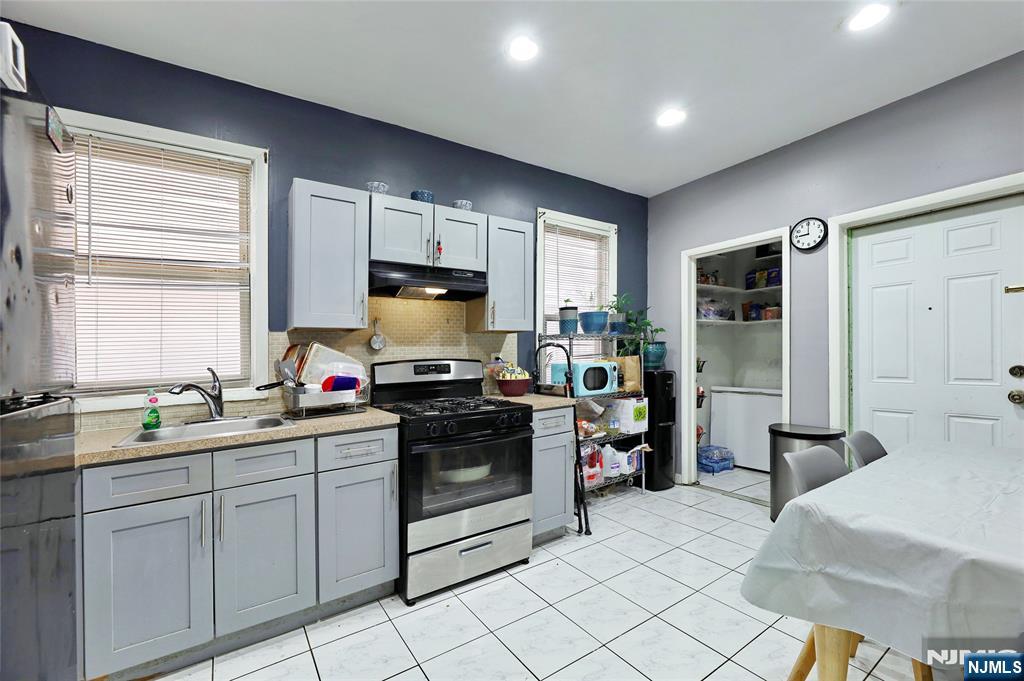 119 Ridgewood Avenue Newark, NJ 07108 - Photo 32 of 38 a kitchen with a sink stove and refrigerator