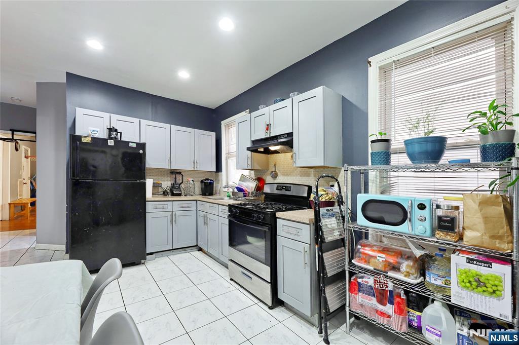 119 Ridgewood Avenue Newark, NJ 07108 - Photo 33 of 38 a kitchen with stainless steel appliances granite countertop a refrigerator and a stove