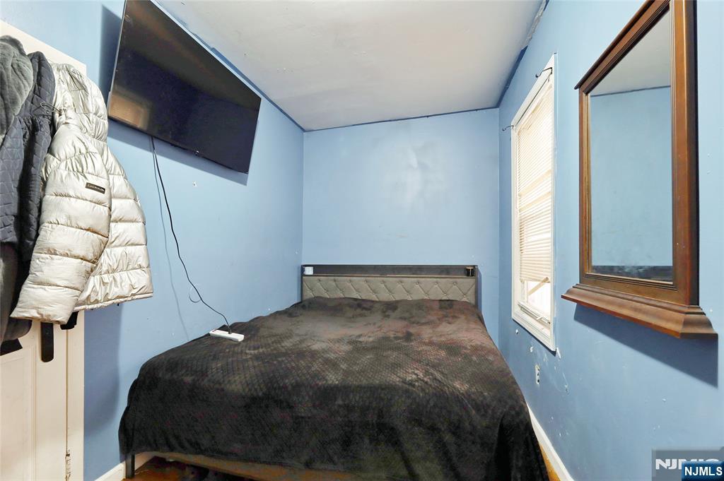 119 Ridgewood Avenue Newark, NJ 07108 - Photo 34 of 38 a bedroom with a bed tv and a window