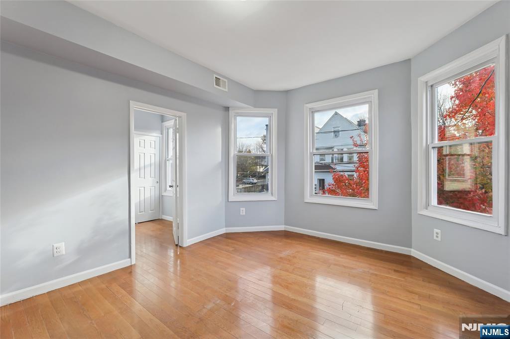 119 Ridgewood Avenue Newark, NJ 07108 - Photo 9 of 38 wooden floor in an empty room with a window