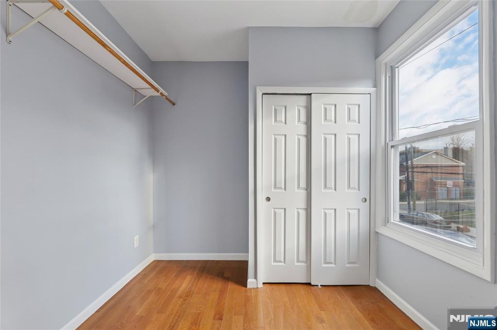 119 Ridgewood Avenue Newark, NJ 07108 - Photo 10 of 38 wooden floor in an empty room with a window