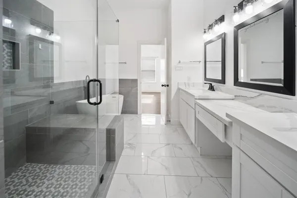 a bathroom with a double vanity sink a toilet and a mirror