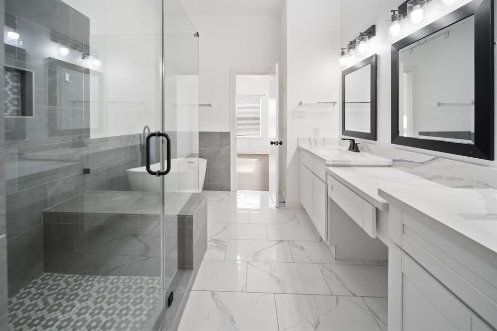 7650 Springhill Street, Unit 403 Houston, TX 77021 - Photo 18 of 30 a bathroom with a double vanity sink a toilet and a mirror