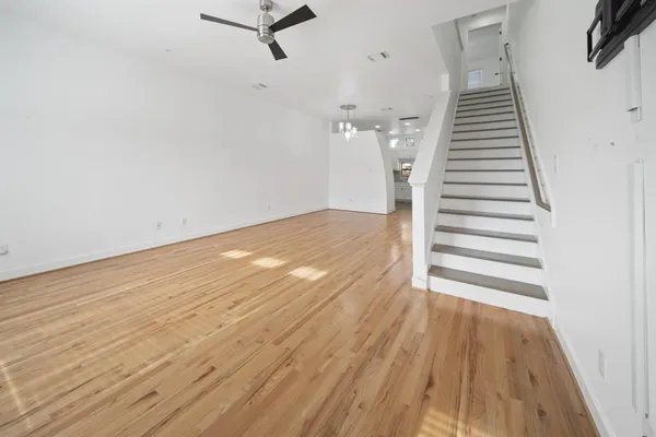 a view of a room with wooden floor and white walls