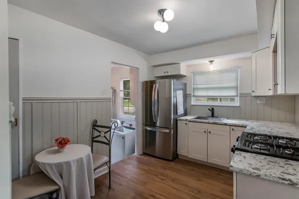a kitchen with a sink refrigerator and cabinets