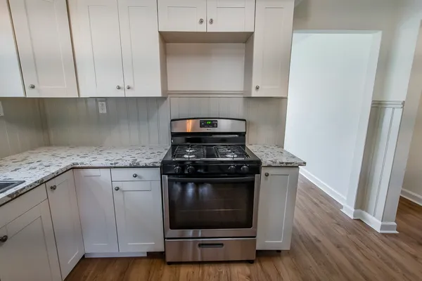 a stove top oven sitting inside of a kitchen