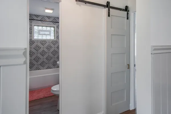 a bathroom view of a toilet and a shower