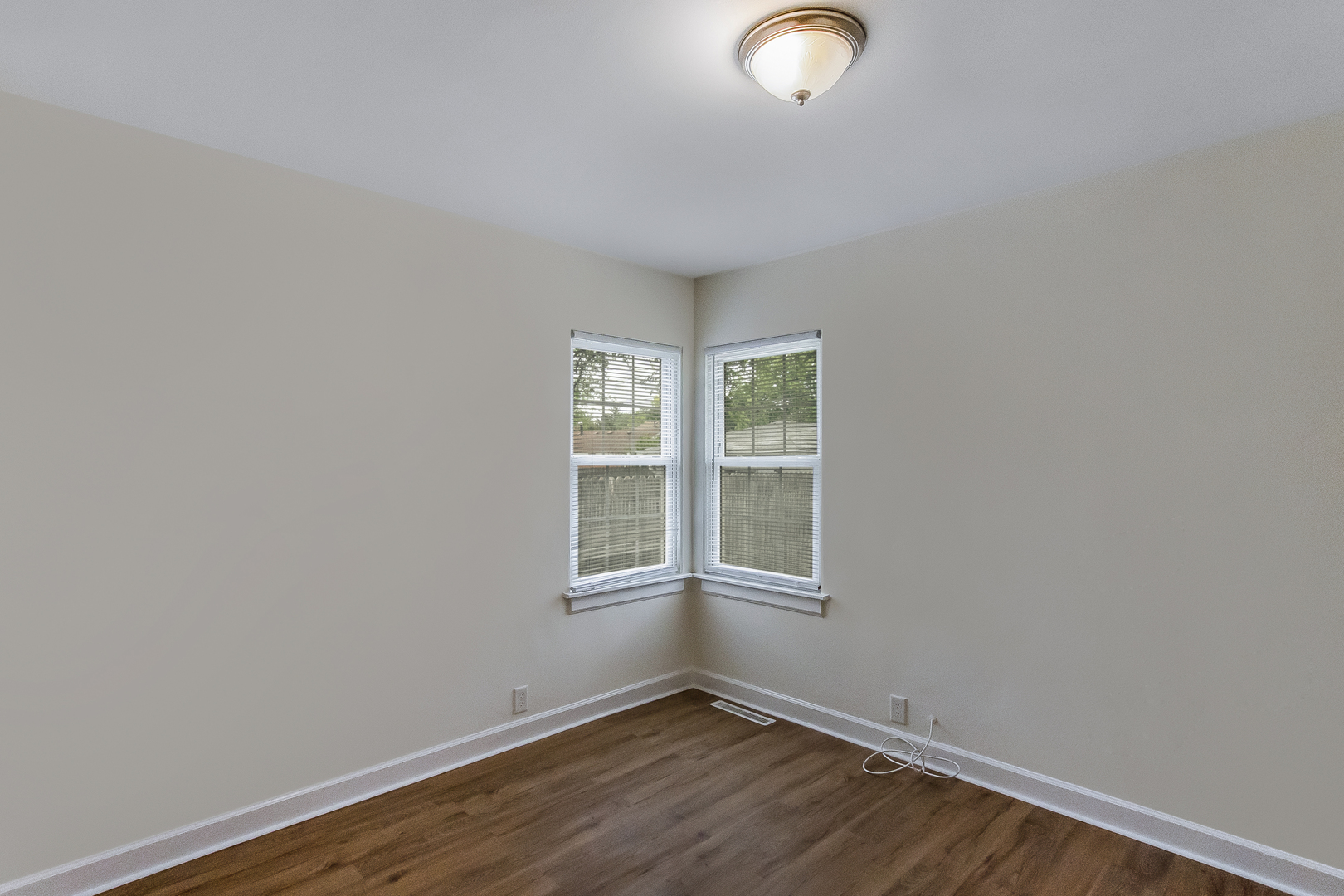 130 South Park Road Joliet, IL 60433 - Photo 17 of 22 an empty room with wooden floor and windows