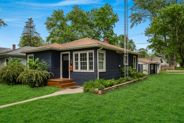 a view of a house with a yard and garden
