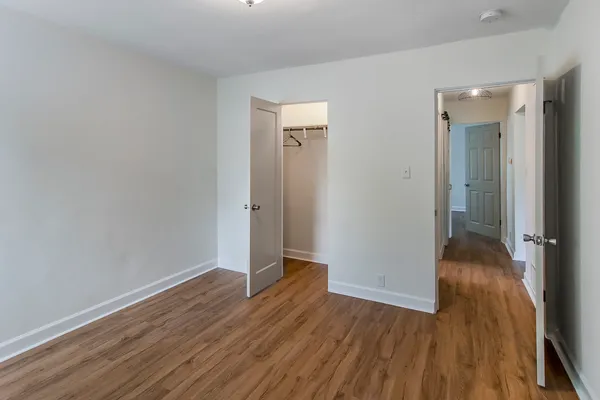 a view of a hallway with wooden floor