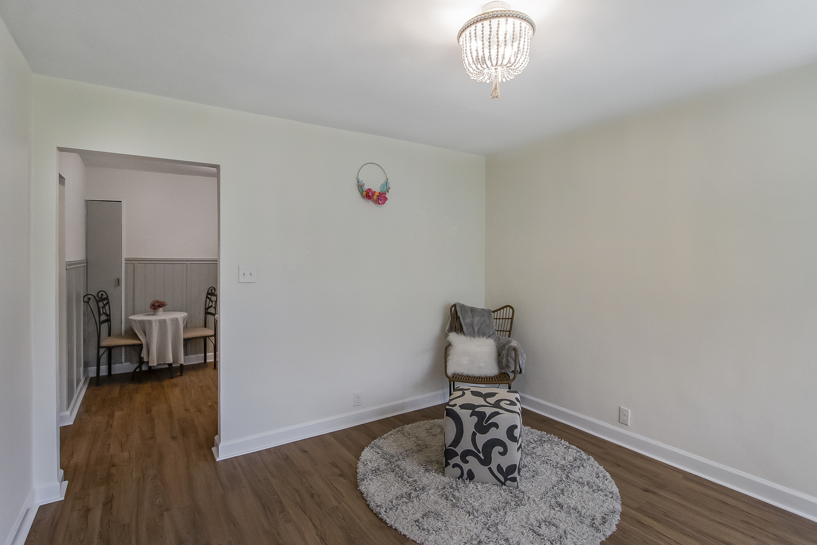 130 South Park Road Joliet, IL 60433 - Photo 8 of 22 a view of a livingroom with wooden floor and a chandelier
