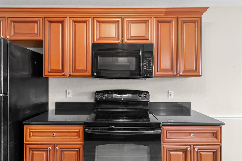 503 Caddell Street Aubrey, TX 76227 - Photo 18 of 39 a stove top oven sitting inside of a kitchen