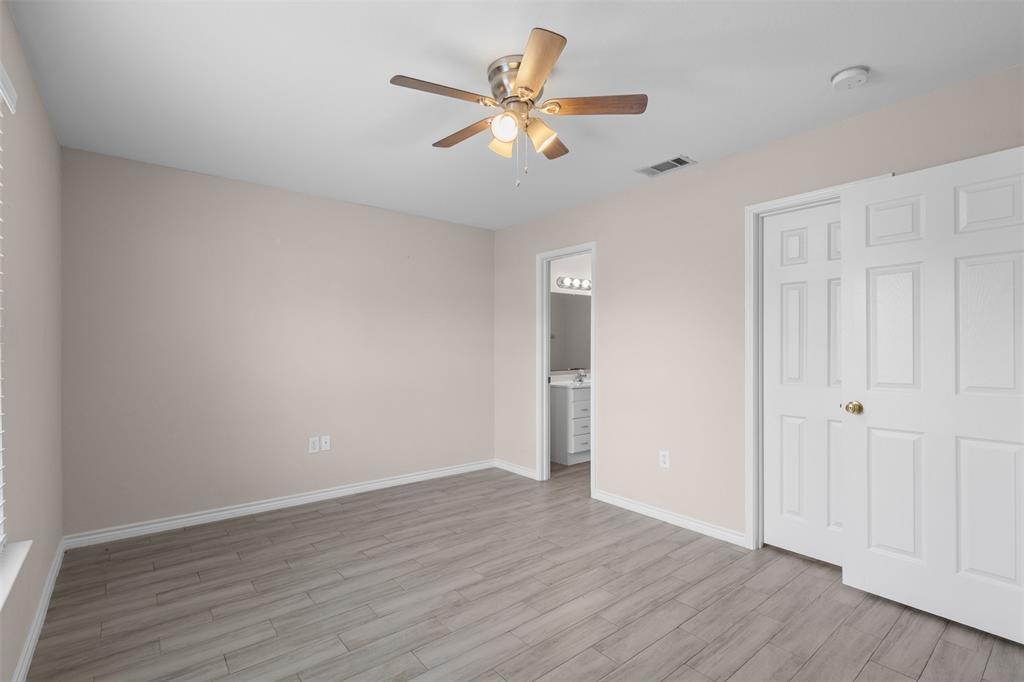 503 Caddell Street Aubrey, TX 76227 - Photo 23 of 39 an empty room with wooden floor ceiling fan and window