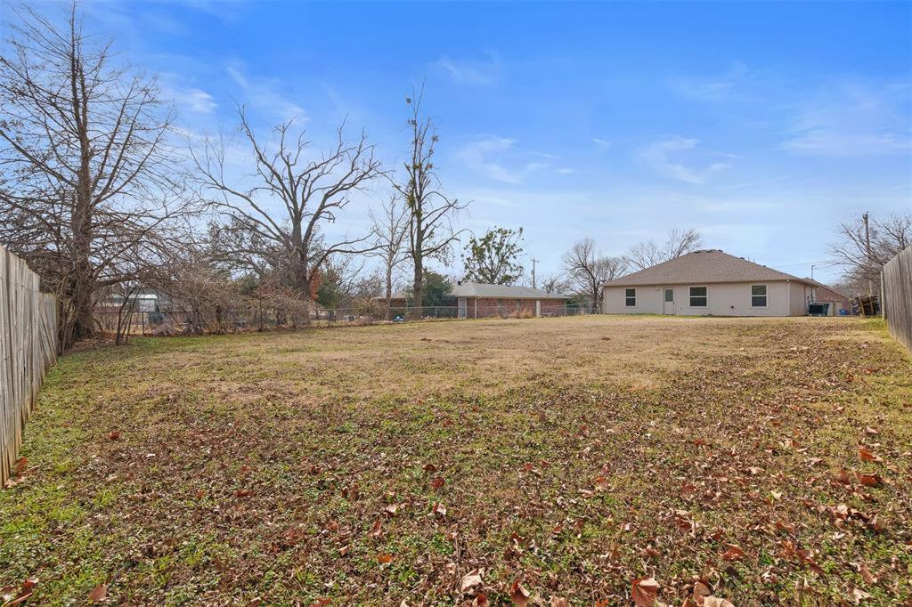 503 Caddell Street Aubrey, TX 76227 - Photo 35 of 39 a view of house with yard and trees in the background