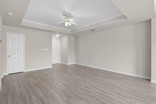 a view of an empty room with wooden floor