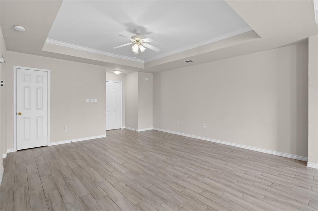 503 Caddell Street Aubrey, TX 76227 - Photo 9 of 39 a view of an empty room with wooden floor