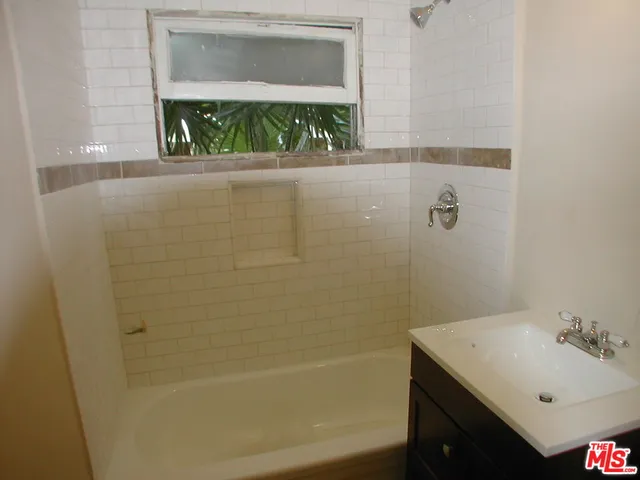 a bathroom with a bathtub and a sink