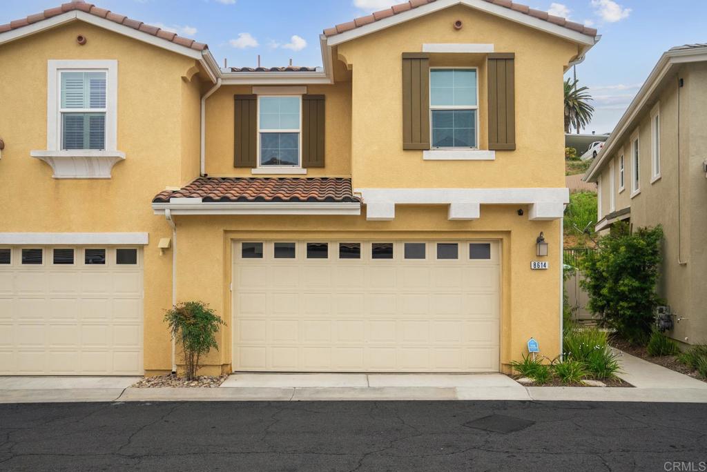 8614 Skylight Way El Cajon, CA 92021 - Photo 1 of 65 a front view of a house with a yard and garage