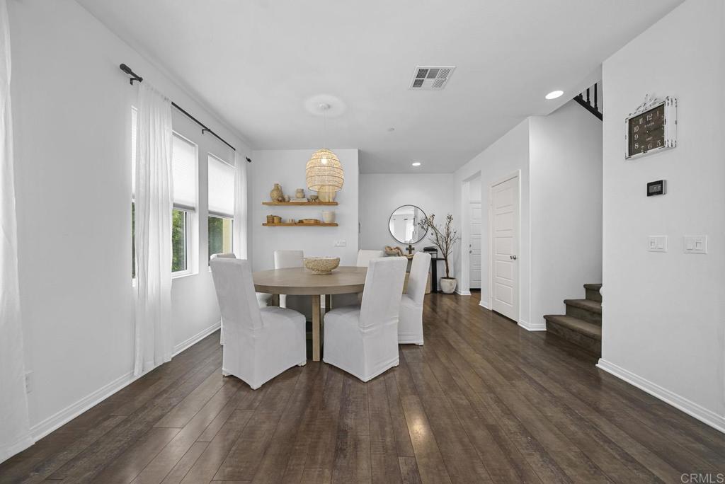 8614 Skylight Way El Cajon, CA 92021 - Photo 12 of 65 a view of a dining room with furniture window and wooden floor