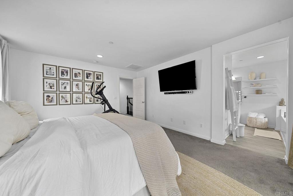 8614 Skylight Way El Cajon, CA 92021 - Photo 16 of 65 a bedroom with a large bed and a flat screen tv