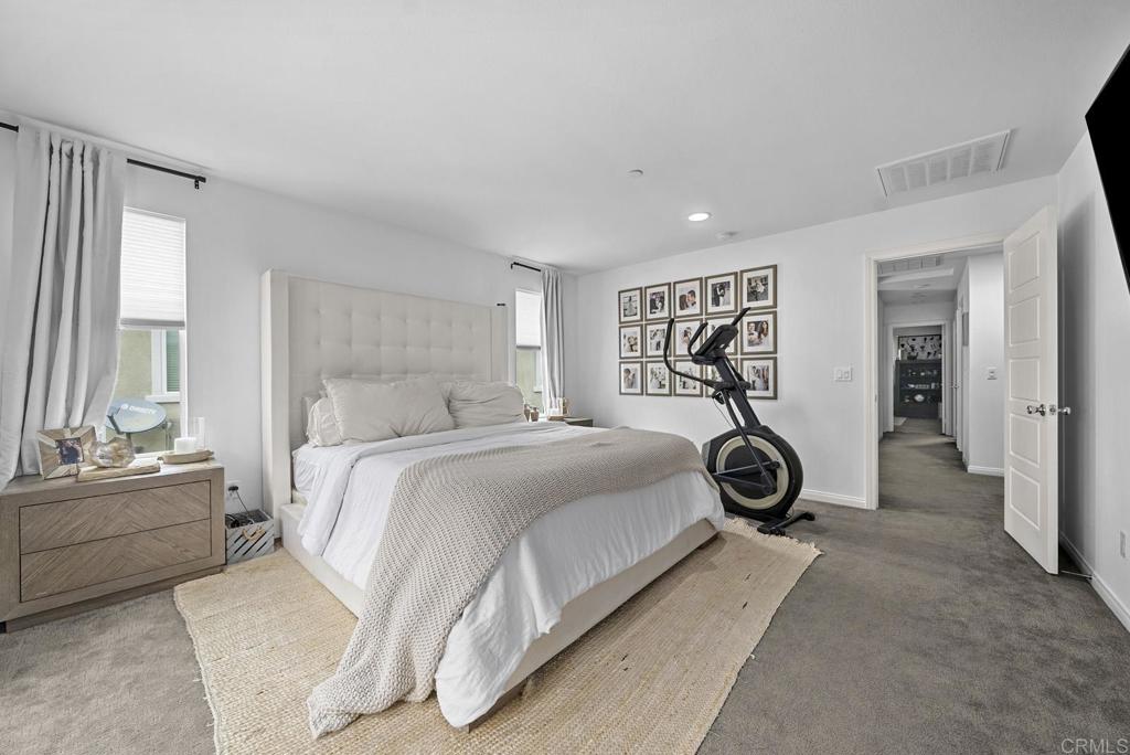 8614 Skylight Way El Cajon, CA 92021 - Photo 18 of 65 a bedroom with a bed and a chandelier