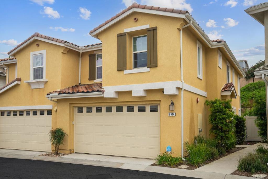 8614 Skylight Way El Cajon, CA 92021 - Photo 2 of 65 a front view of a house with a garage
