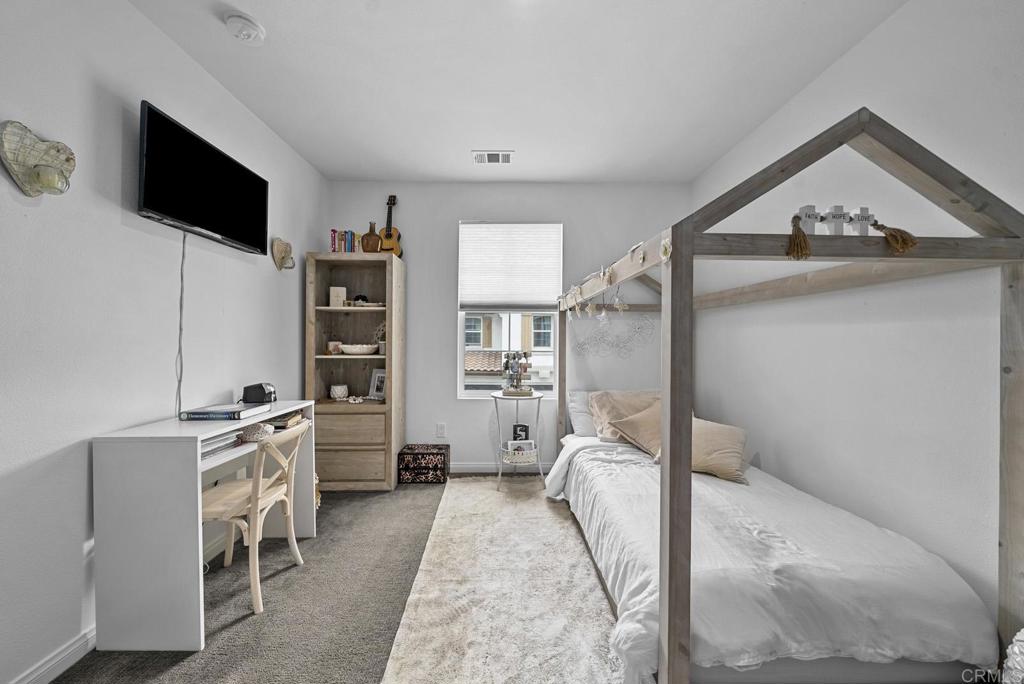 8614 Skylight Way El Cajon, CA 92021 - Photo 25 of 65 a view of a livingroom with furniture and a flat screen tv