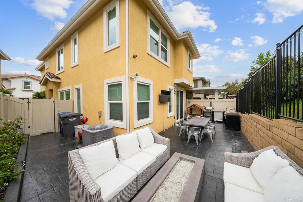 8614 Skylight Way El Cajon, CA 92021 - Photo 33 of 65 a view of a patio with couches table and chairs and potted plants