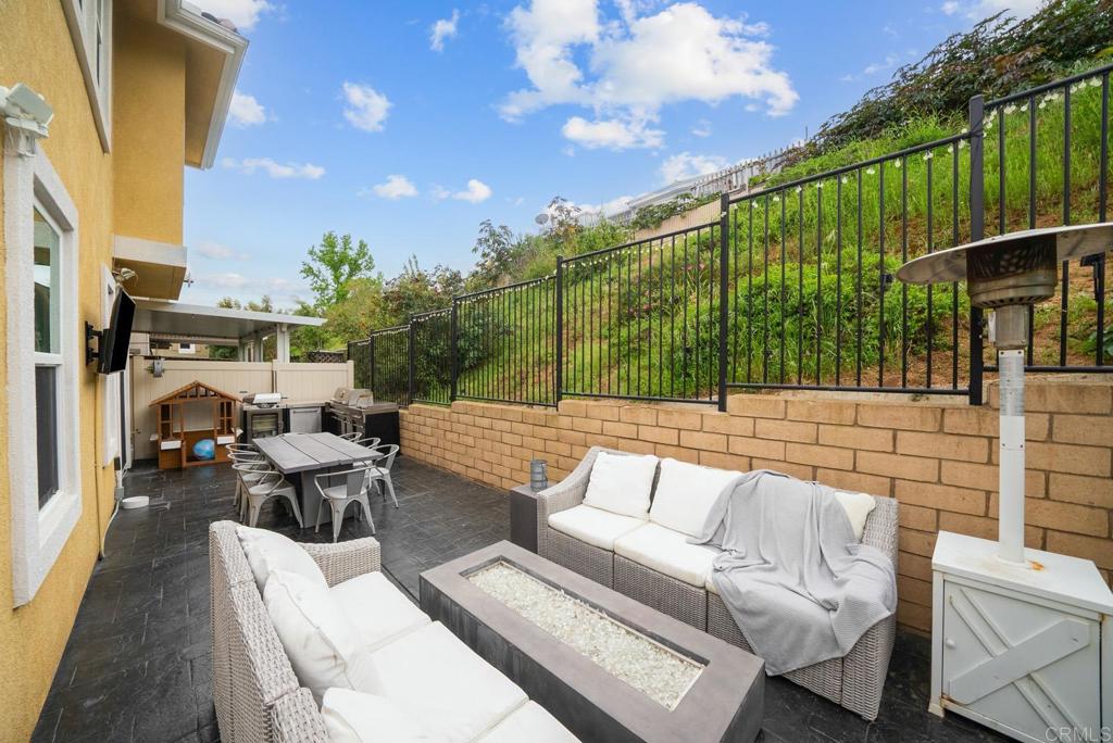 8614 Skylight Way El Cajon, CA 92021 - Photo 35 of 65 a view of a patio with couches table and chairs and potted plants