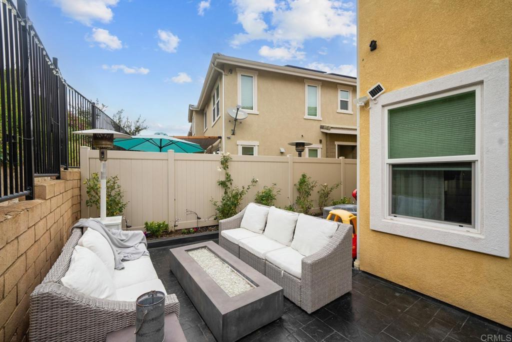 8614 Skylight Way El Cajon, CA 92021 - Photo 36 of 65 a view of a patio with couches table and chairs with wooden floor