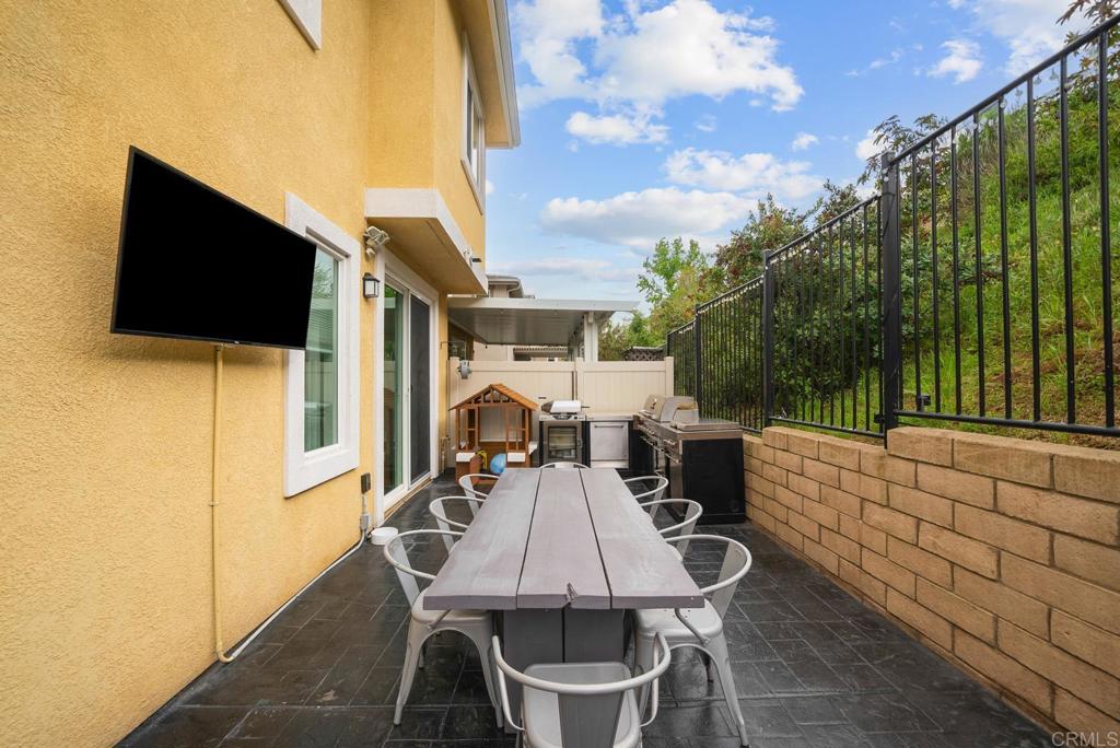 8614 Skylight Way El Cajon, CA 92021 - Photo 42 of 65 a view of a patio with table and chairs with wooden floor and fence