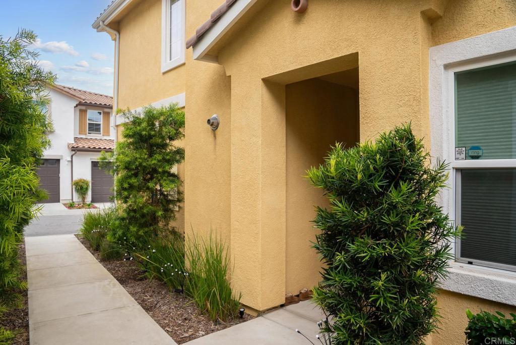 8614 Skylight Way El Cajon, CA 92021 - Photo 51 of 65 a front view of a house with trees