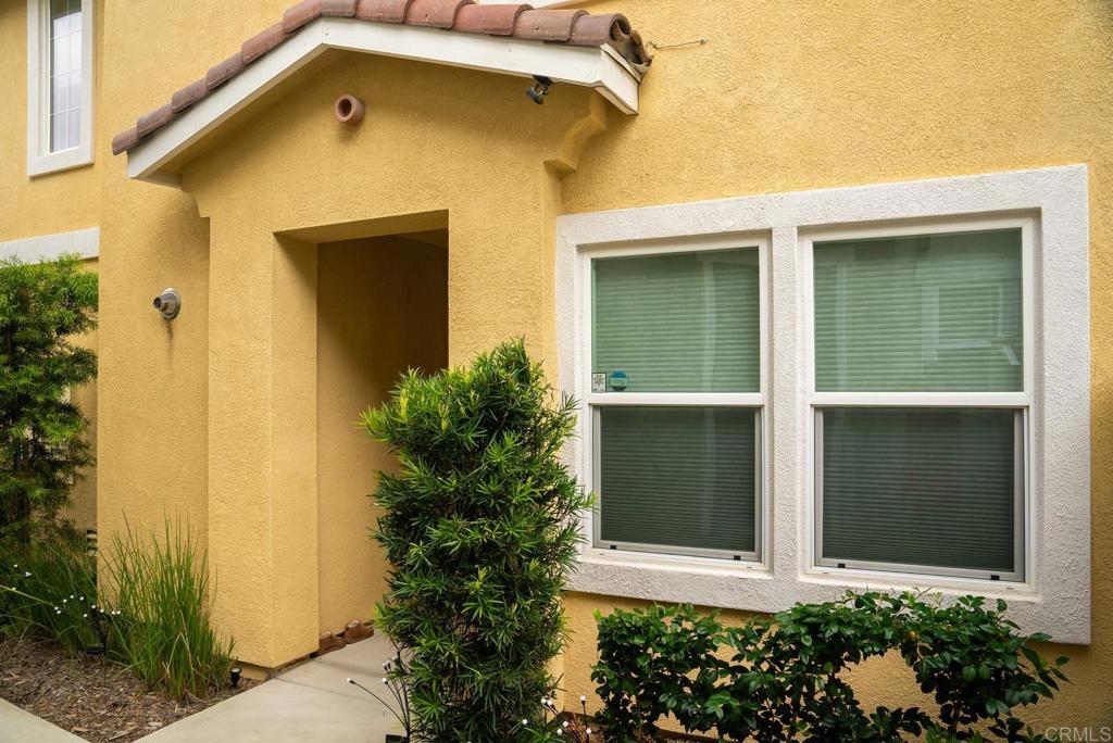 8614 Skylight Way El Cajon, CA 92021 - Photo 53 of 65 a front view of a house with a yard