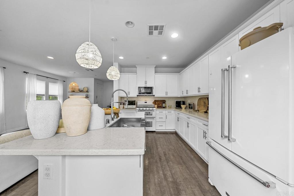 8614 Skylight Way El Cajon, CA 92021 - Photo 8 of 65 a kitchen with counter space cabinets and appliances