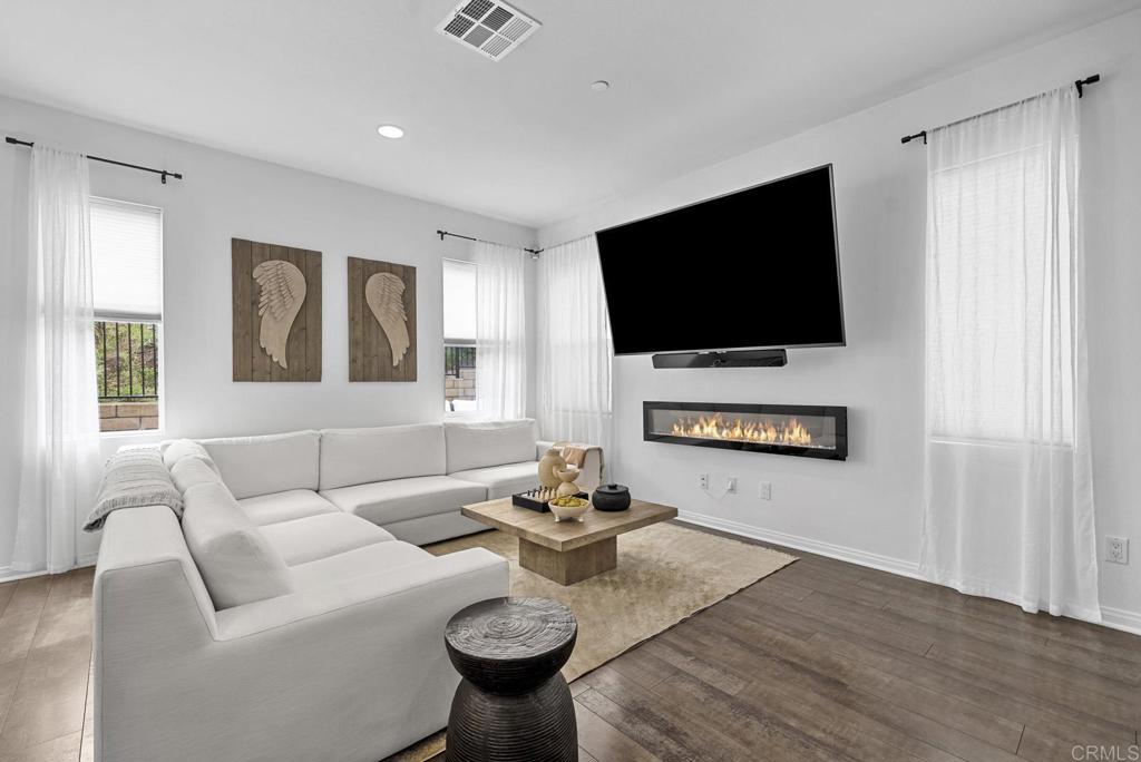 8614 Skylight Way El Cajon, CA 92021 - Photo 9 of 65 a living room with furniture a flat screen tv and a window