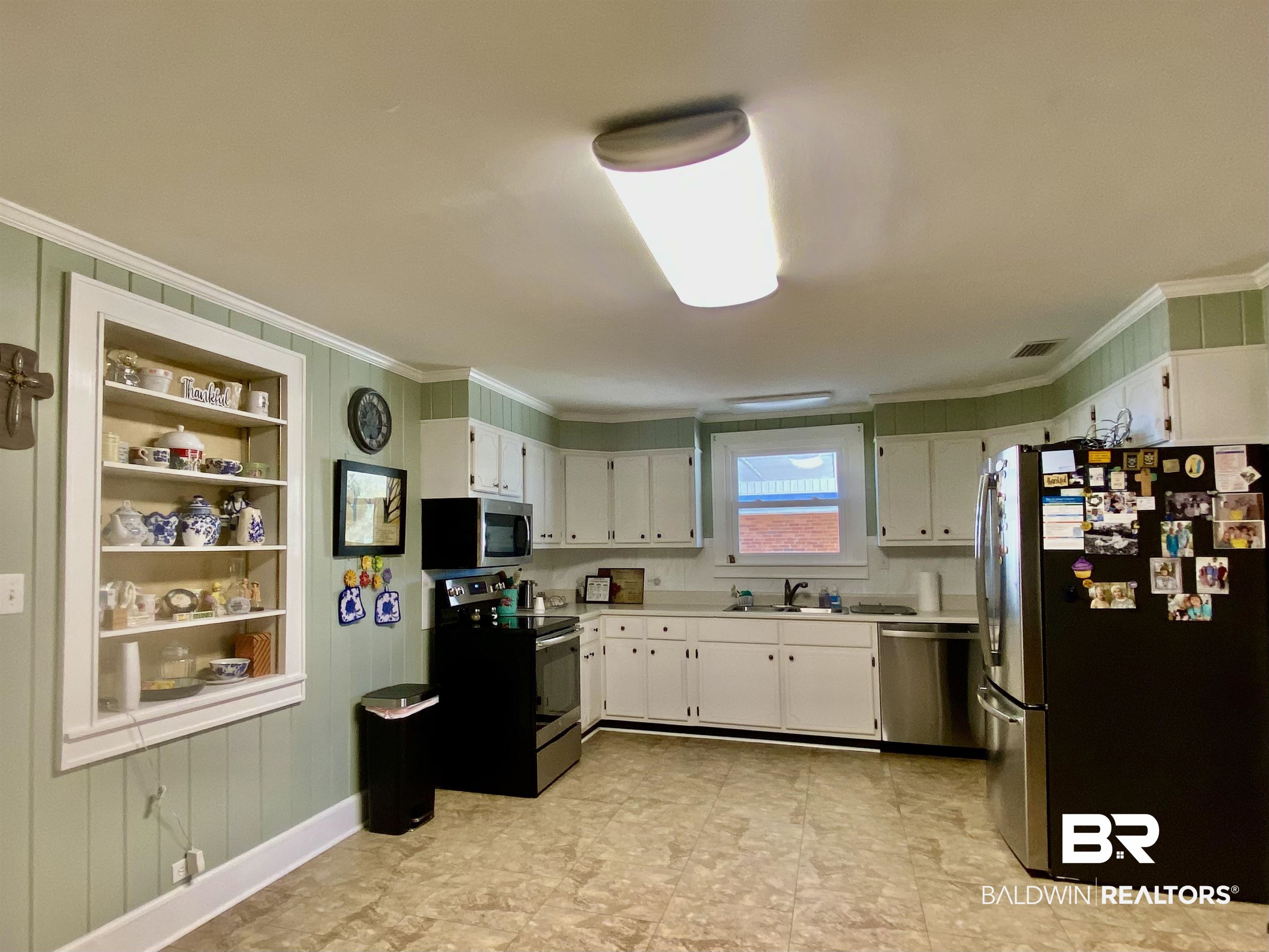 2711 County Road 5 Repton, AL 36475 - Photo 8 of 36 Kitchen with sink, crown molding, stainless steel appliances, and white cabinetry