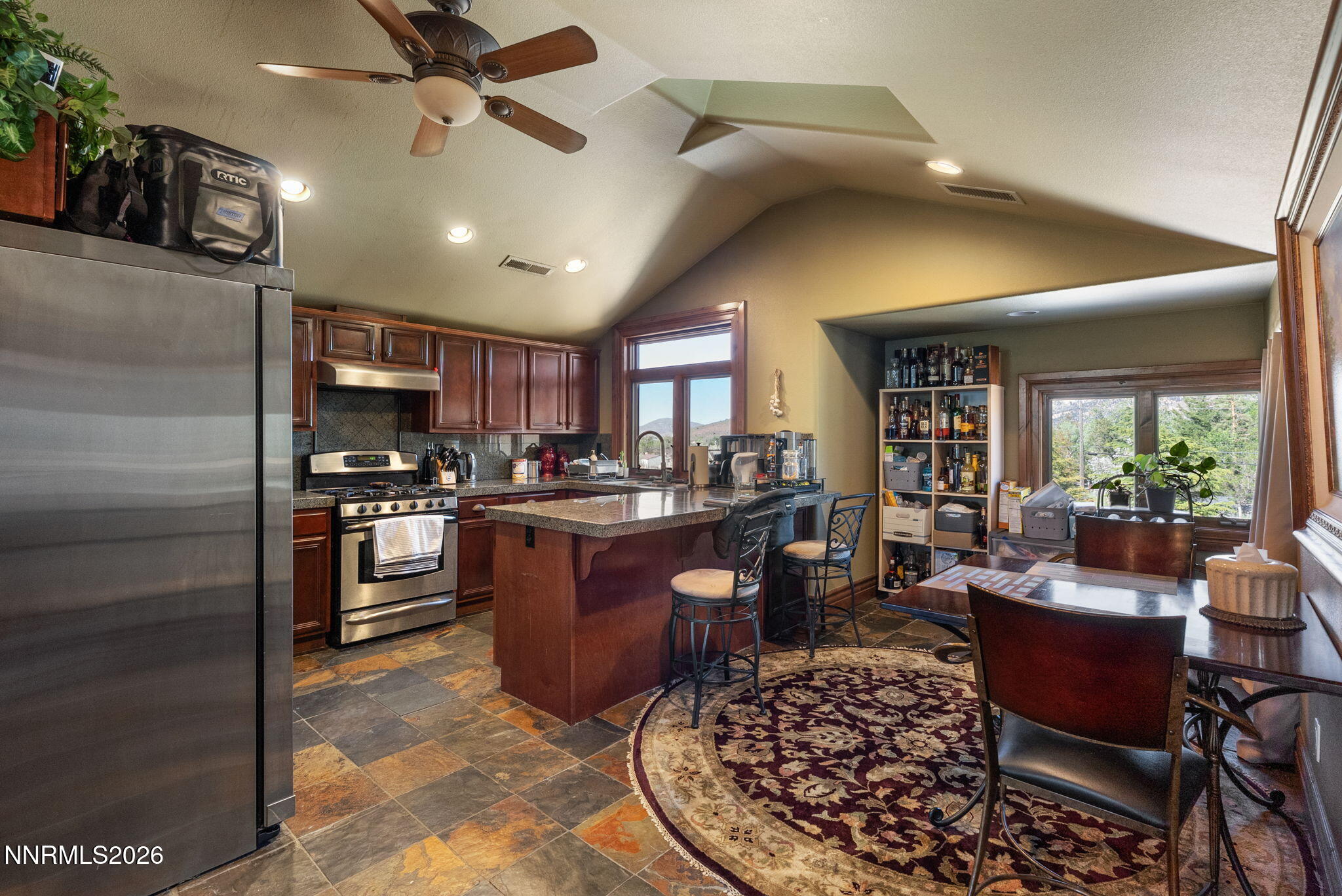 123 Andrew Lane Reno, NV 89521 - Photo 36 of 50 a living room with stainless steel appliances kitchen island granite countertop a refrigerator a stove a sink dishwasher with a dining table and chairs